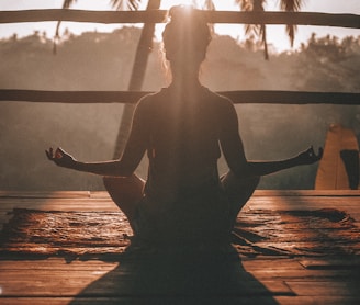 woman doing yoga meditation on brown parquet flooring