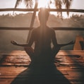 woman doing yoga meditation on brown parquet flooring