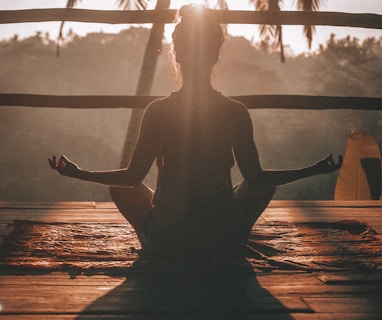 woman doing yoga meditation on brown parquet flooring