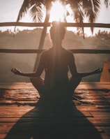 woman doing yoga meditation on brown parquet flooring