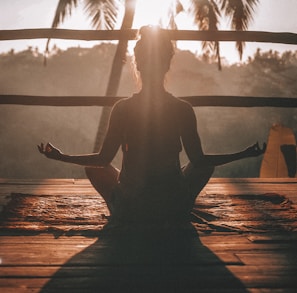 woman doing yoga meditation on brown parquet flooring