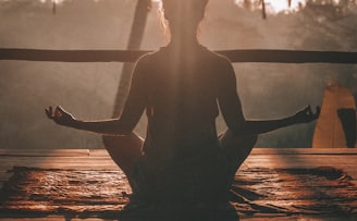 woman doing yoga meditation on brown parquet flooring