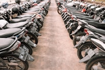 A row of clean and well-maintained motorcycles parked on a vibrant street in Jogjakarta.
