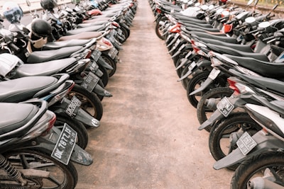 A row of clean and well-maintained motorcycles parked on a vibrant street in Jogjakarta.