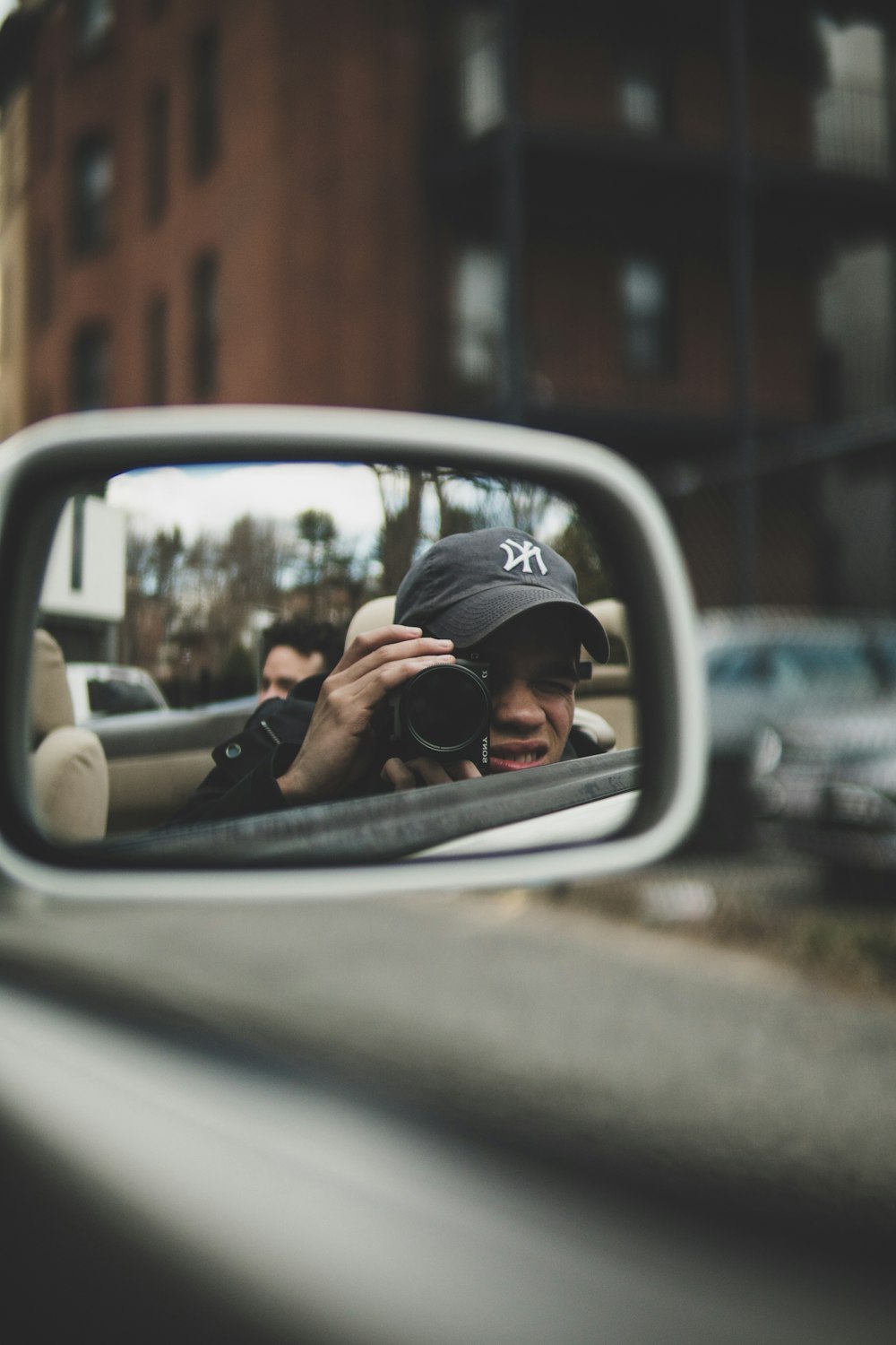 reflection of man taking a photo using DSLR camera