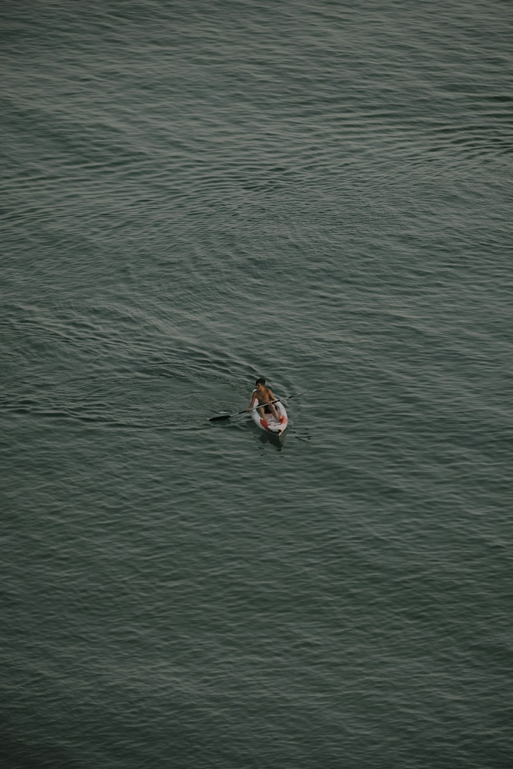 person kayaking on body of water