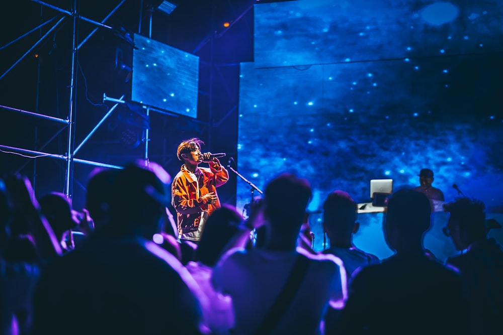 man having concert surrounded with people