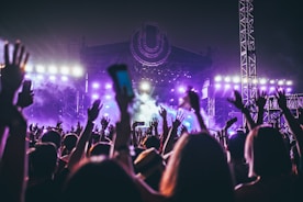 group of people raising there hands in concert