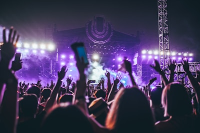 group of people raising there hands in concert
