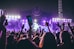 group of people raising there hands in concert