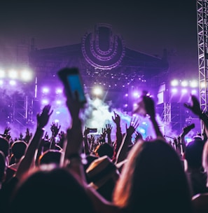 group of people raising there hands in concert