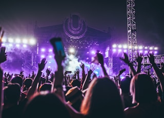 group of people raising there hands in concert