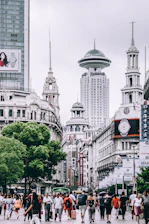 people standing near gray concrete tower