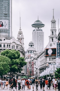 people standing near gray concrete tower