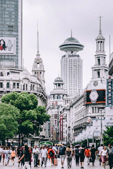 people standing near gray concrete tower