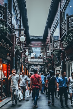 group of people between buildings