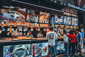 group of people buying food on food stall