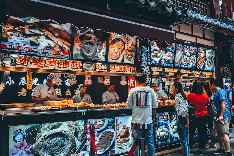 group of people buying food on food stall