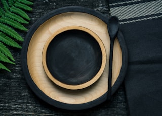 brown and black wooden bowl and plate