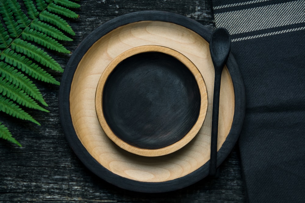 brown and black wooden bowl and plate