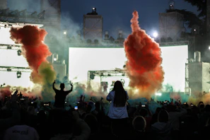 Smoke and colorful lights creating an energetic atmosphere at a lively event hosted by Ritmovivo.