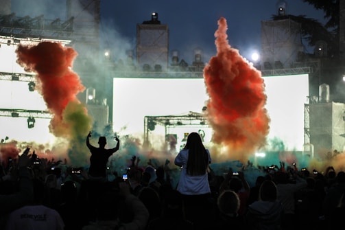 Smoke machines creating atmospheric effects at a lively concert.