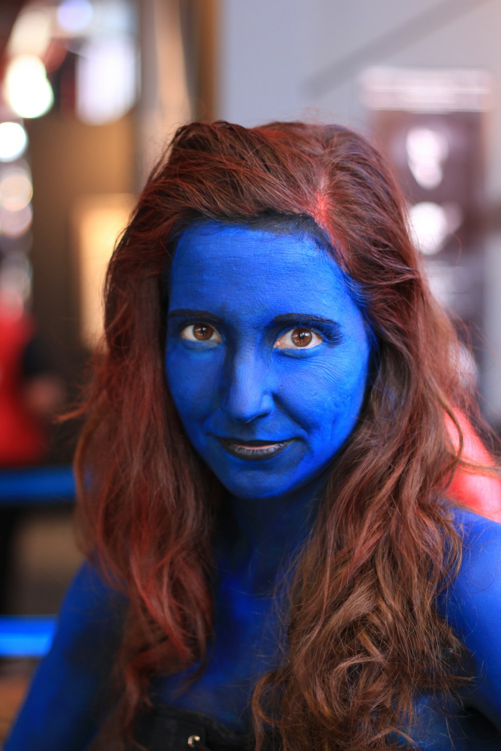 woman with blue bodypaint in selective focus photography