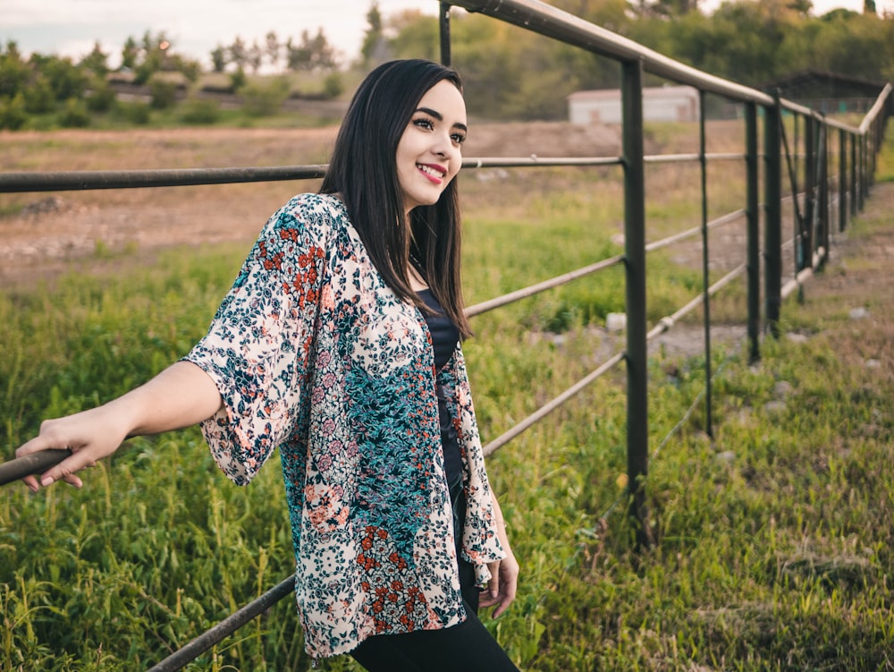 woman wearing blue and white top near metal wall