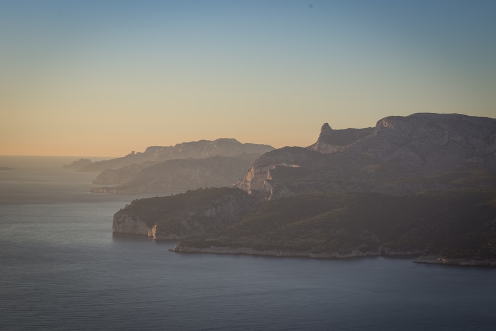 photo of mountain near body of water