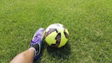 person kicking soccer ball