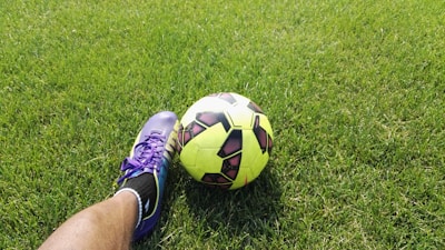 person kicking soccer ball