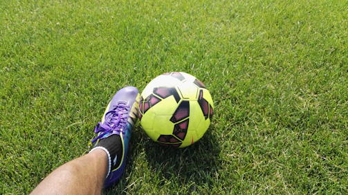 person kicking soccer ball