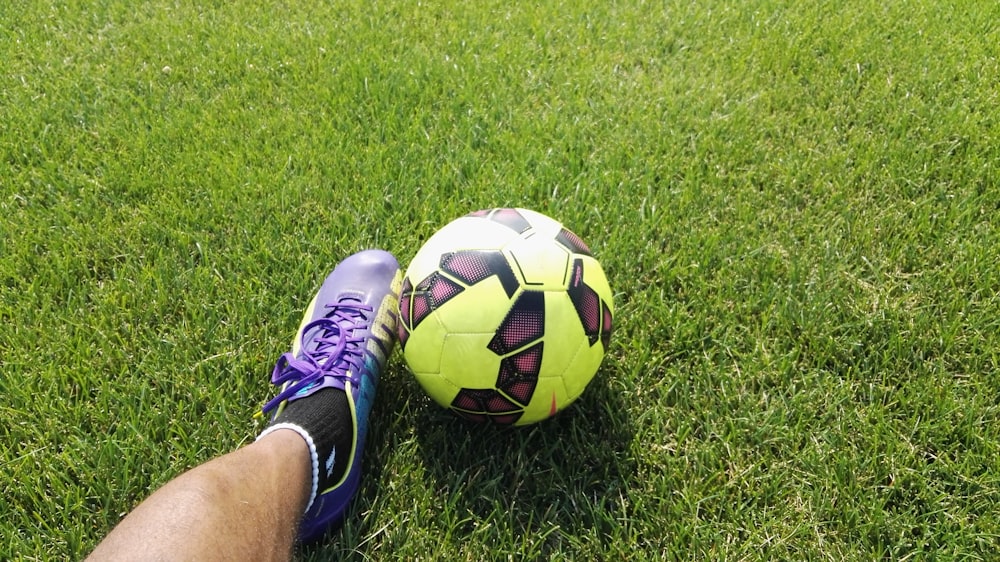 person kicking soccer ball