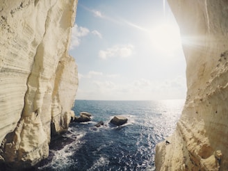 Golden sunlight casting warm hues over the turquoise waters of Sohoton Cove, with limestone cliffs rising majestically.