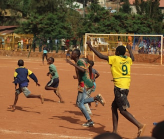 people running on soccer field during daytime