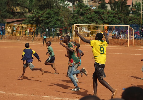 people running on soccer field during daytime