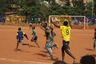 people running on soccer field during daytime