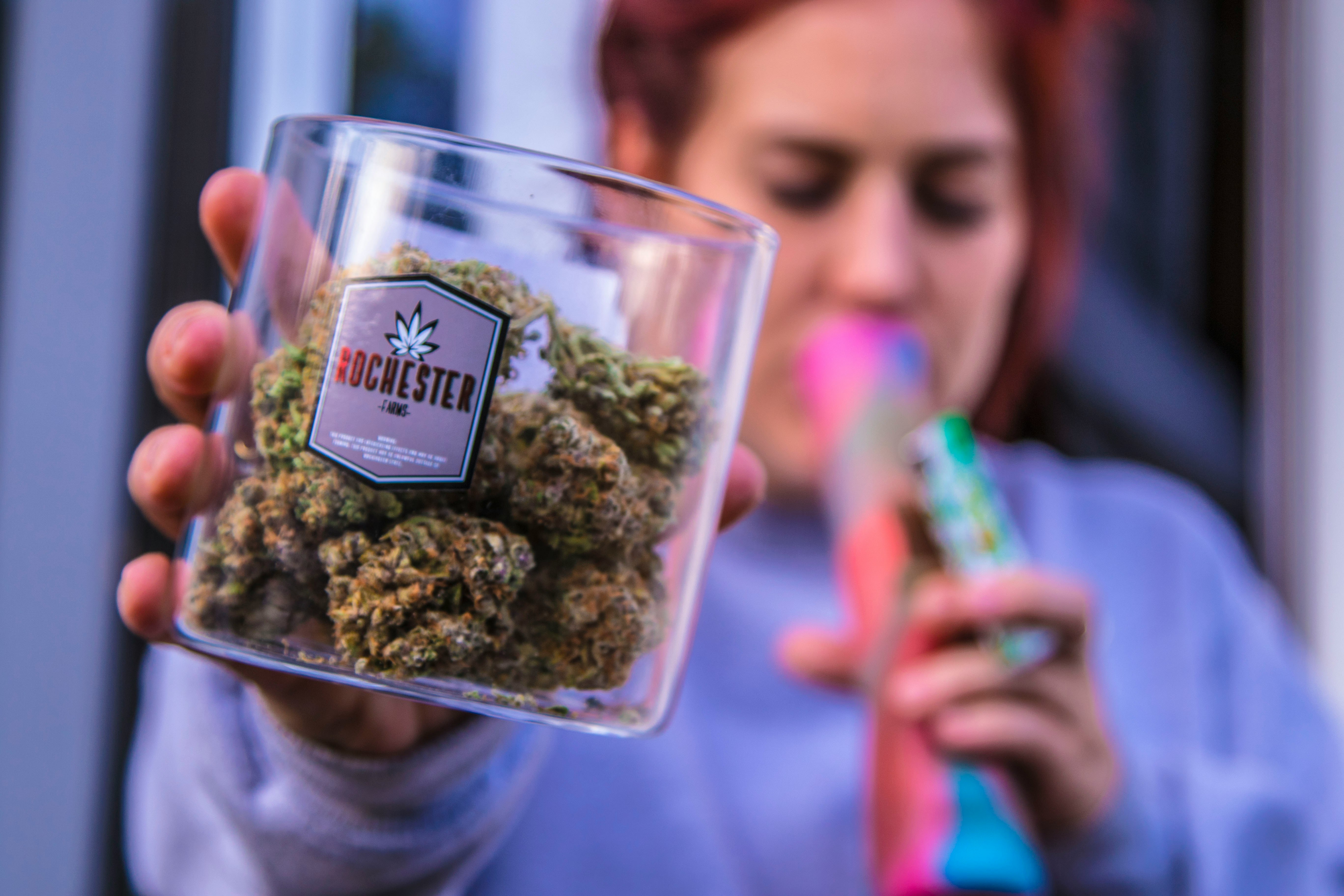 woman holding Rochester kush container