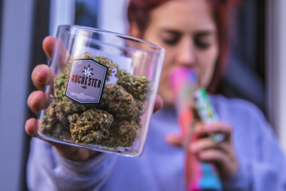 woman holding Rochester kush container