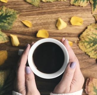 person holding cup filled with coffee