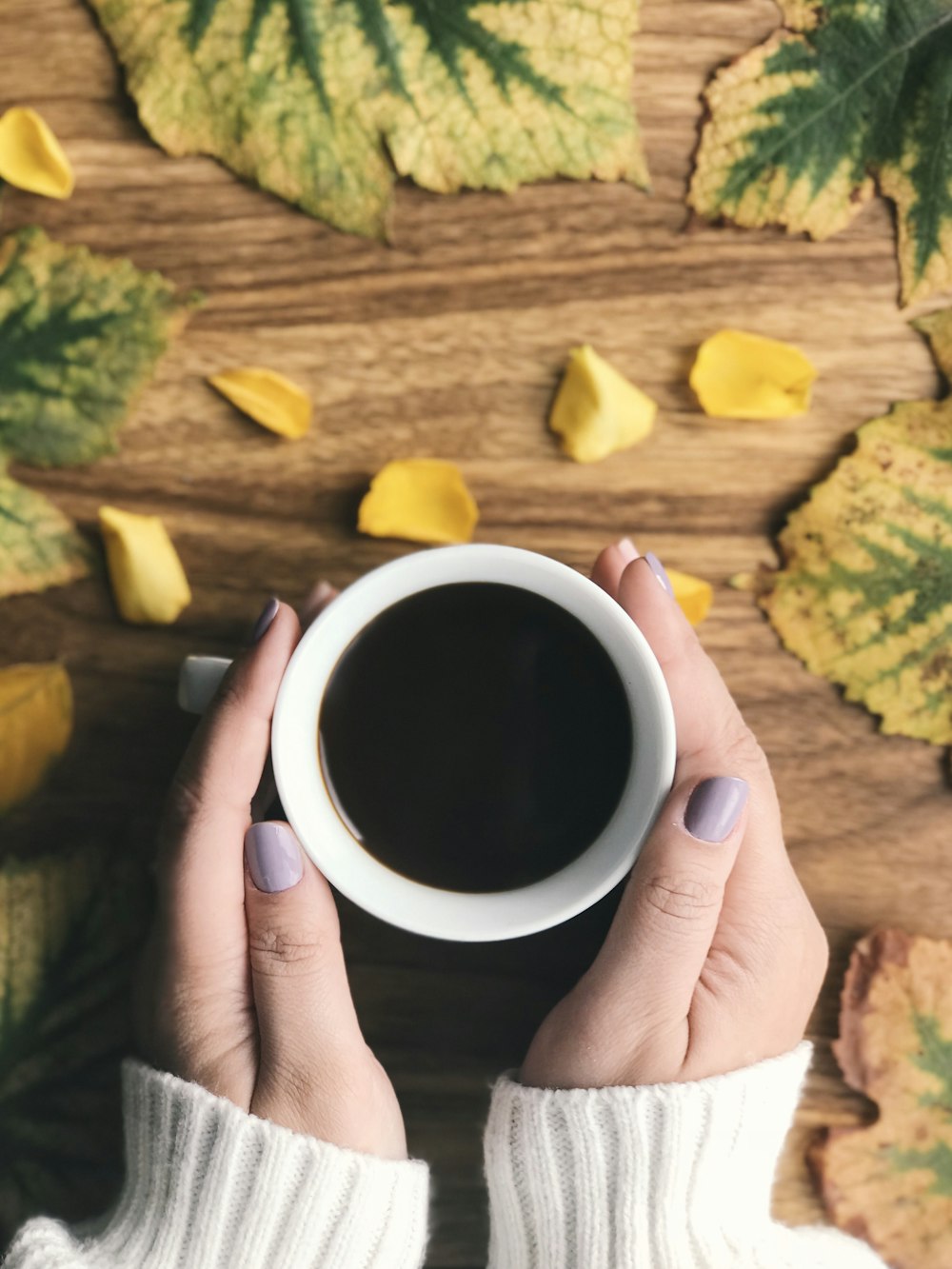 person holding cup filled with coffee