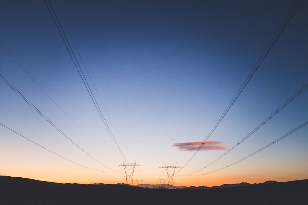 two transmission towers during golden hour