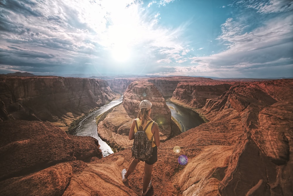 woman standing on top of canyon