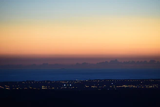 A serene landscape combining ukiyo-e style waves with neon city lights.