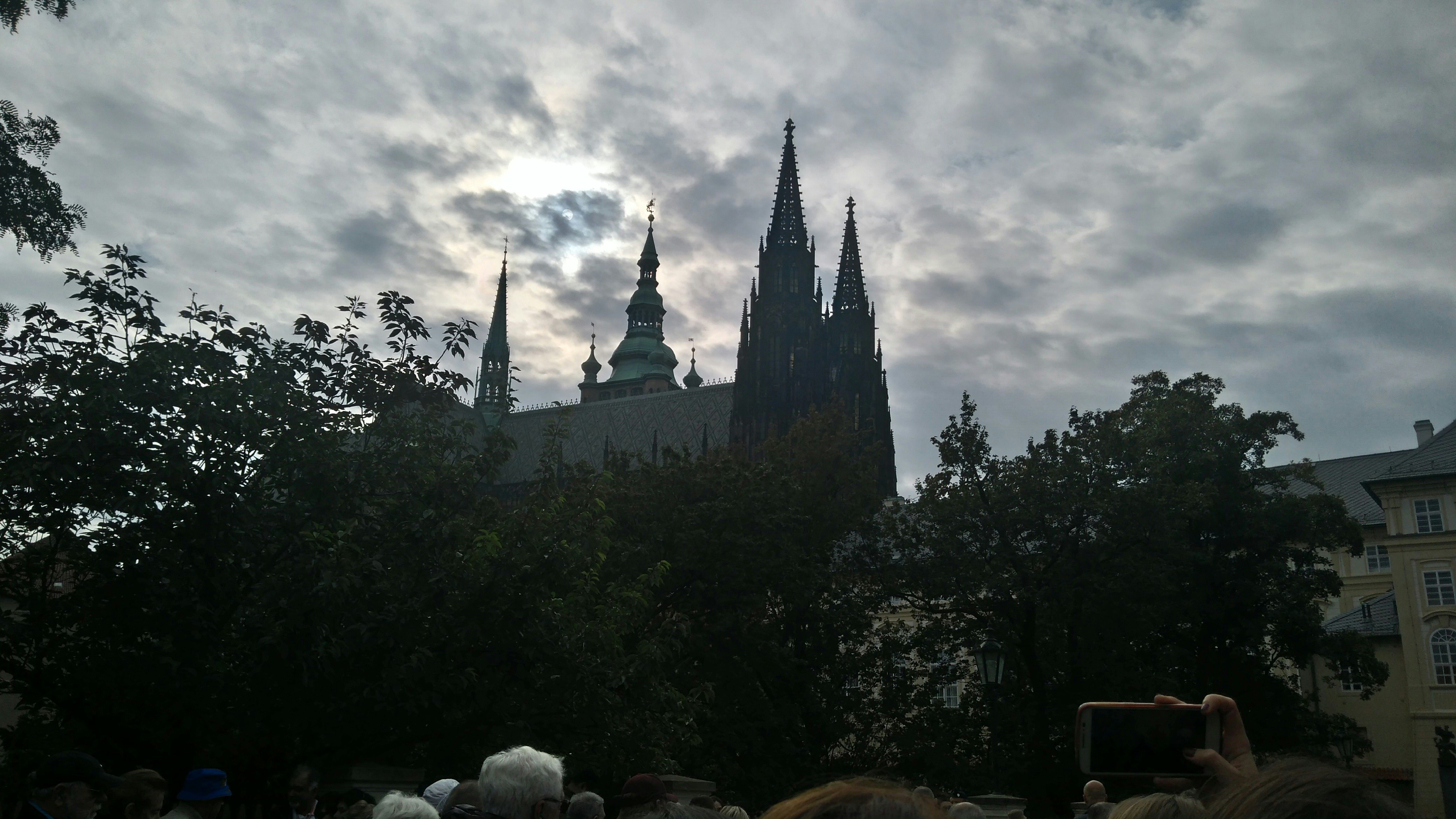 Gothic cathedral silhouette against a dark stormy sky evoking gothic metal atmosphere