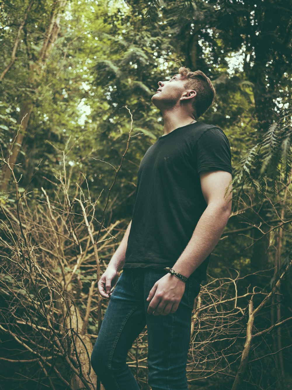 man standing near trees