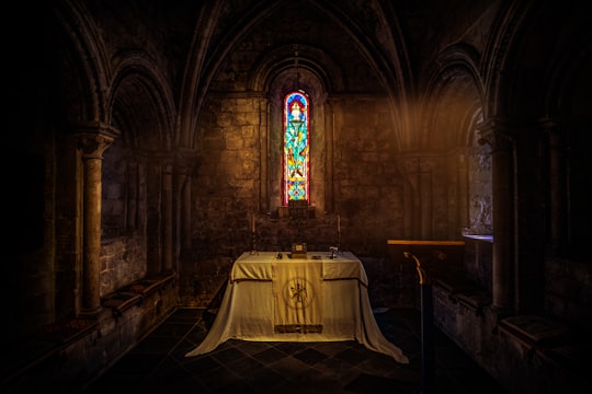 white table near brown wall inside church in Dover Castle United Kingdom