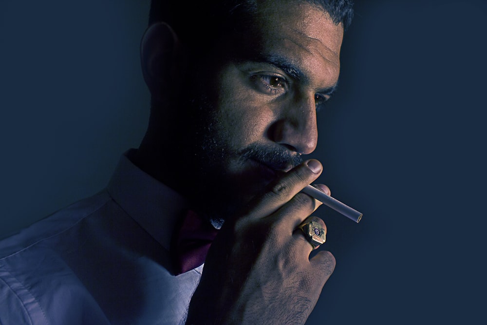 man holding cigarette stick