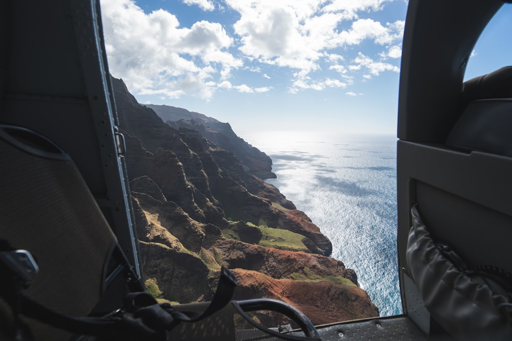 aerial photography of a stone cliff and body of water