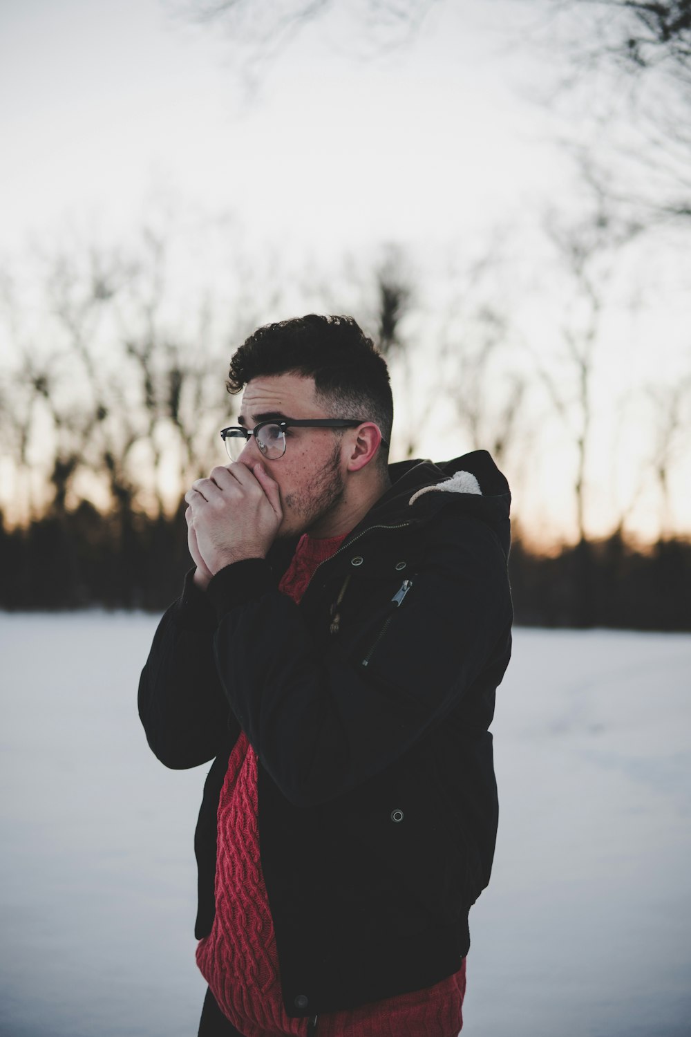 man placing his hands on his mouth